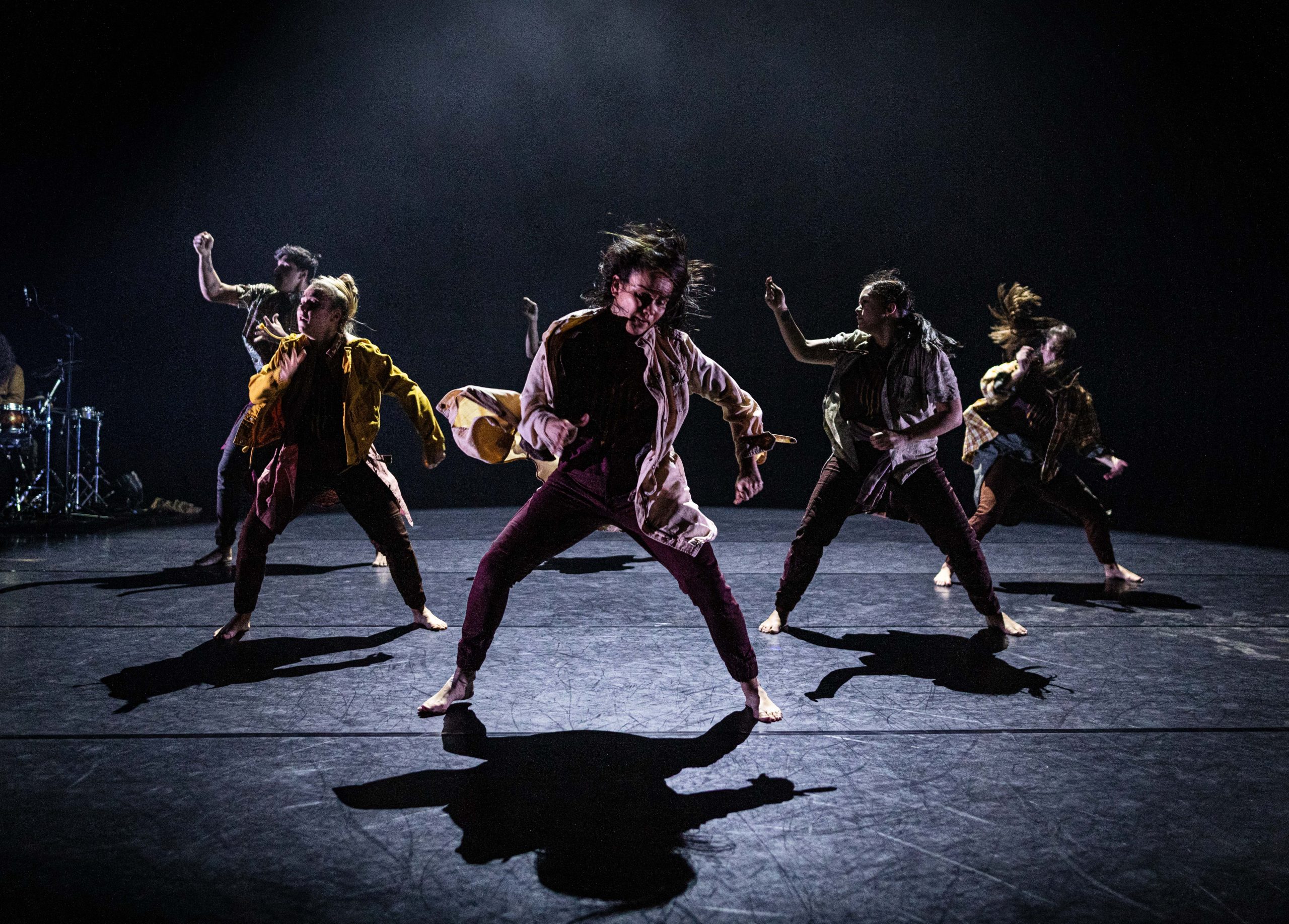 Dancers perform SILENCE on a dark stage